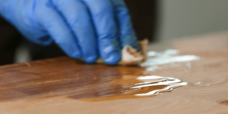 Tâche de pâte à bruler sur table basse en bois
