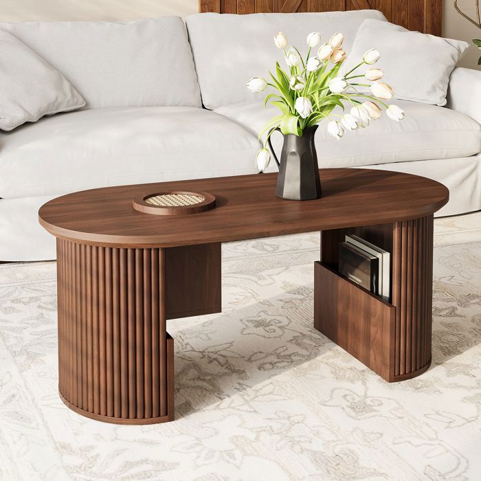 Table basse ovale 105x50x46.5 cm avec rangements intégrés. structure stable. MDF coloris noyer