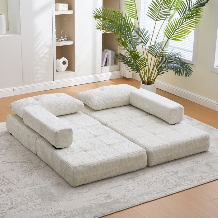Canapé-lit pliable en chenille beige avec coussins et dossier