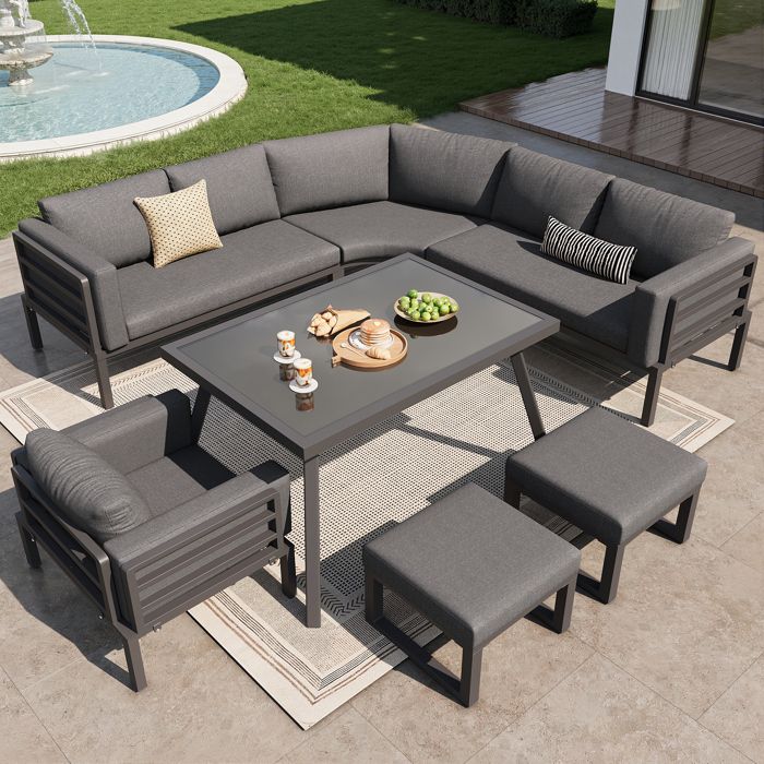 Ensemble de salon de jardin en forme de croissant pour huit personnes avec coussins table en verre fauteuils et tabourets gris