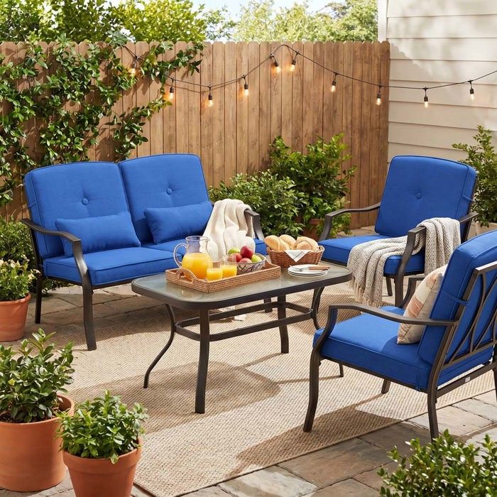 Ensemble de table et chaises de jardin - 4 places - Structure métallique renforcée - Coussins bleus amovibles - Table verre trempé