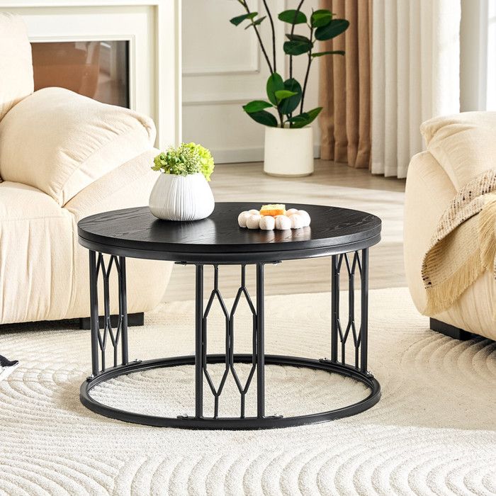 Table basse rondeplateau imitation bois noircadre métallique à découpes losangéestable détente style minimaliste